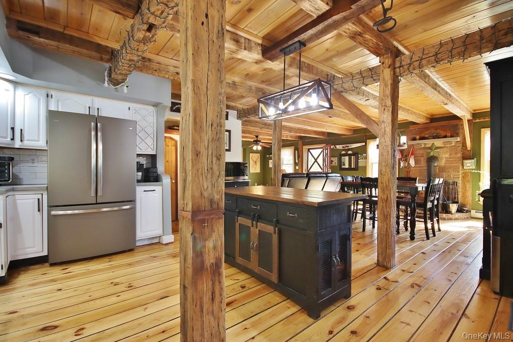 575 Roosa Gap Road Bloomingburg, NY 12721 - Photo 21 of 50 a kitchen with stainless steel appliances granite countertop a refrigerator a stove and a wooden floors