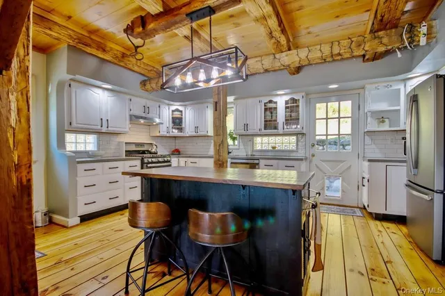 a kitchen with stainless steel appliances granite countertop a sink and cabinets