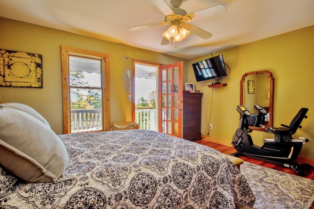 575 Roosa Gap Road Bloomingburg, NY 12721 - Photo 28 of 50 a bedroom with a bed and wooden floor