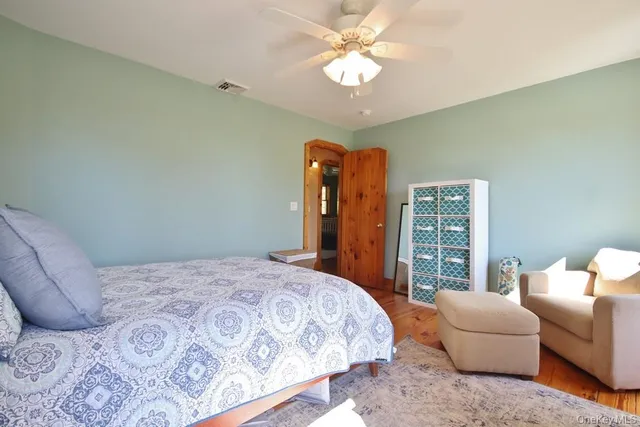 a bedroom with a bed couch and a large window