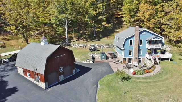 a view of a house with a yard and sitting area