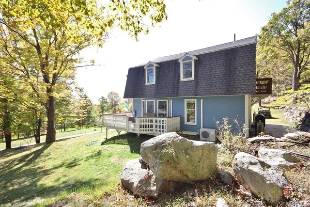 a view of a house with backyard porch and sitting area