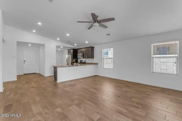 a view of a kitchen with a sink and a window