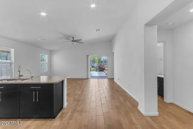 wooden floor in an empty room with a kitchen