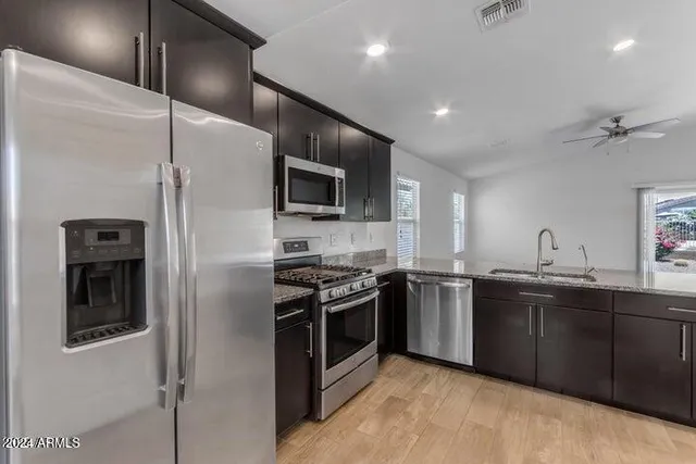 a view of kitchen with refrigerator and window