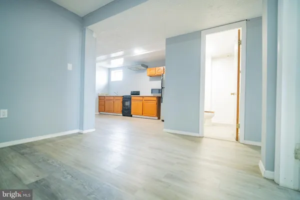 a view of a kitchen cabinets and wooden floor
