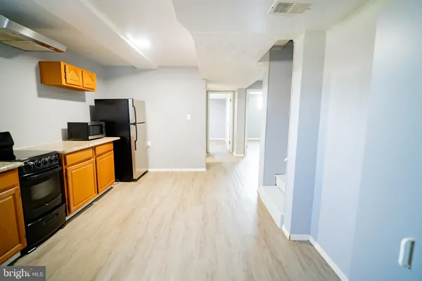 a kitchen with stainless steel appliances a stove top oven a sink dishwasher and a refrigerator