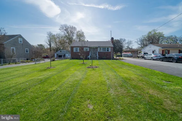 a view of a house with a yard and sitting area