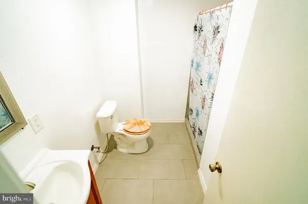 a white toilet sitting next to a bathroom sink