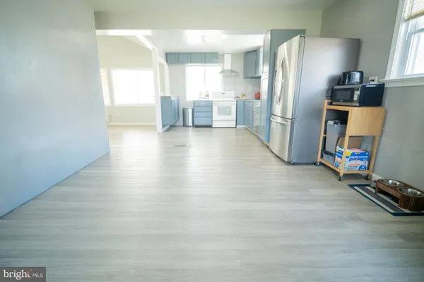 a kitchen with stainless steel appliances a refrigerator and a stove top oven