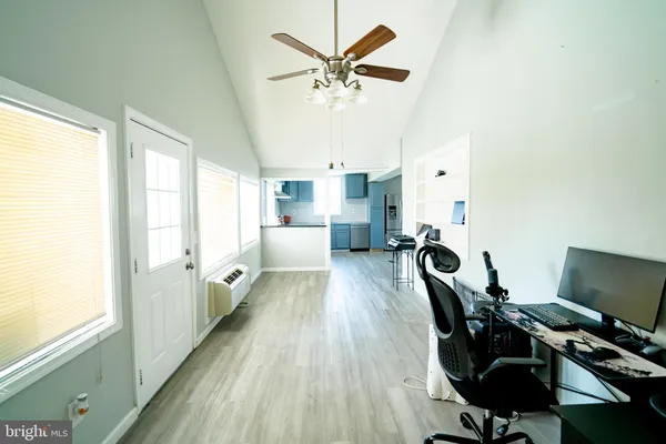 a view of a workspace with furniture and a window