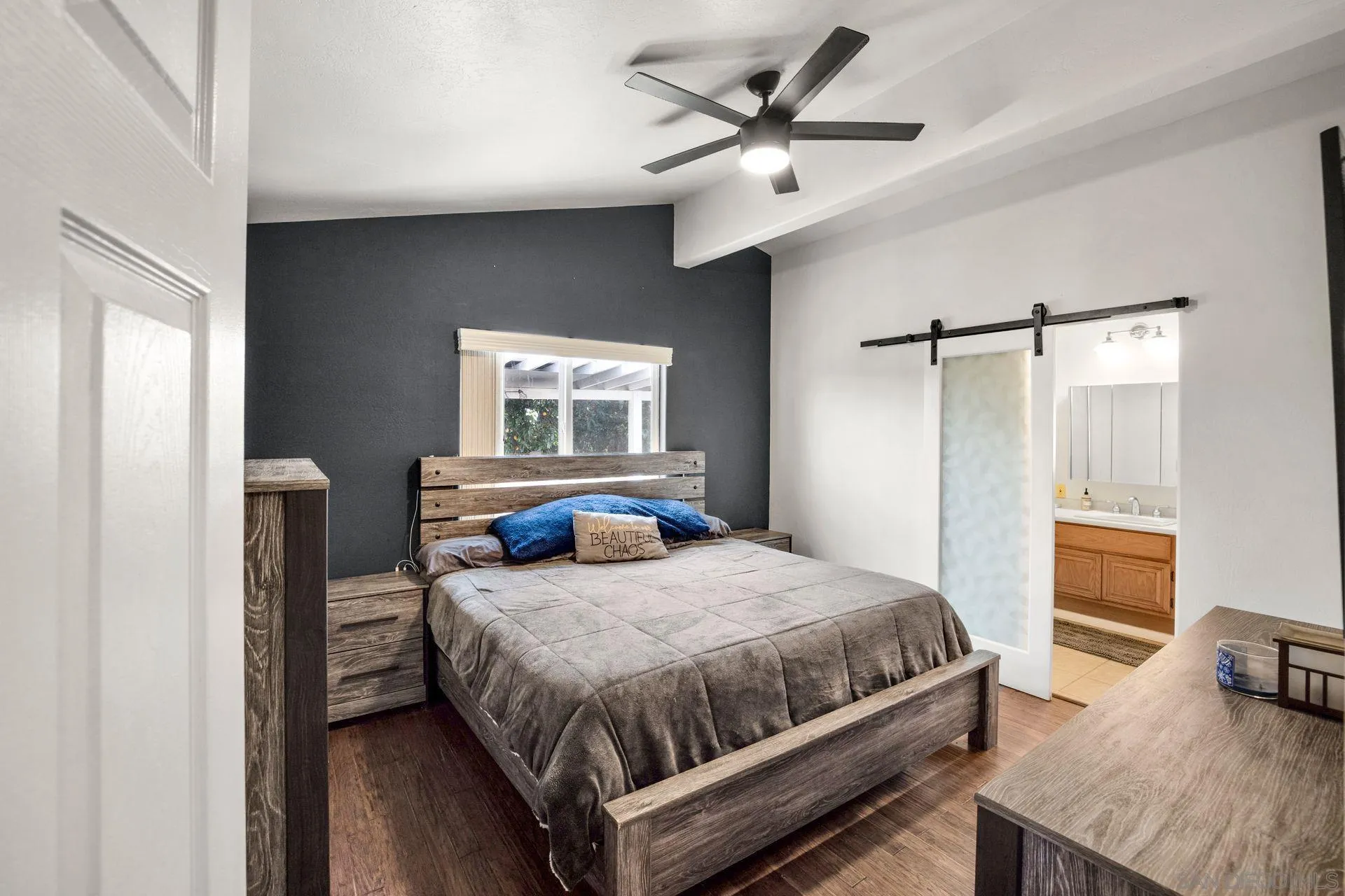 28436 Sunset Road Valley Center, CA 92082 - Photo 15 of 36 a bedroom with a bed a window and flowerpot