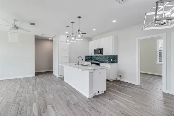 a kitchen with a stove and a microwave