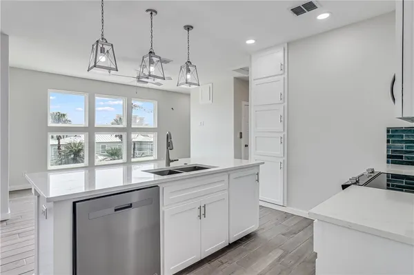 a kitchen with stainless steel appliances a sink stove and refrigerator