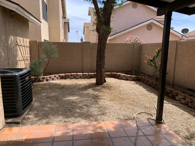 a view of backyard with wooden fence