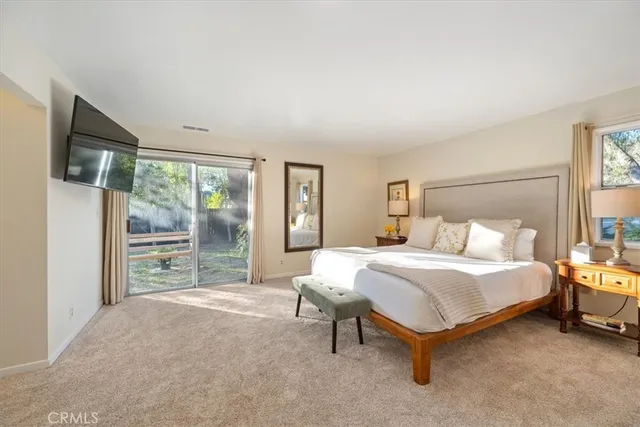 a bathroom with a granite countertop sink a mirror a shower and a bathtub