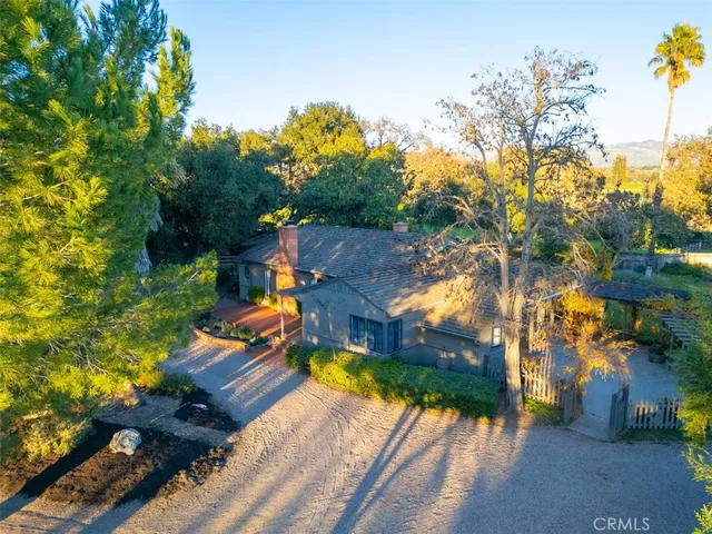 a view of a hallway with wooden floor and a dining room