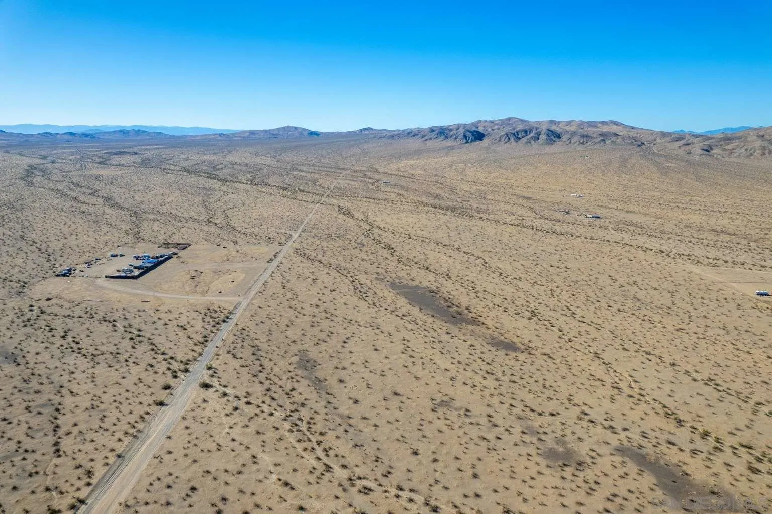 0 Panamint Trail, Unit 29 Helendale, CA 92342 - Photo 5 of 37 a view of a dry yard with mountains in the background
