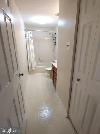 a view of a hallway and a livingroom with furniture