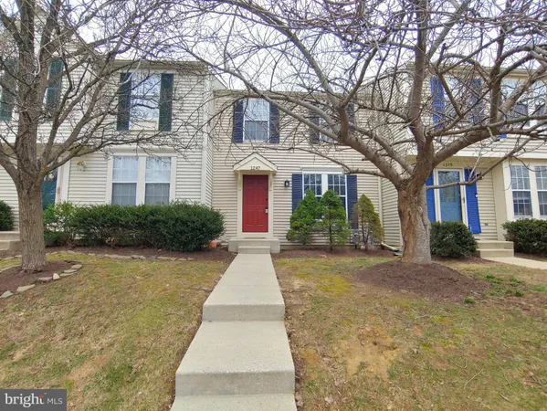 a front view of a house with yard and green space