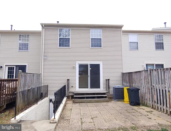 a view of a house with a wooden fence