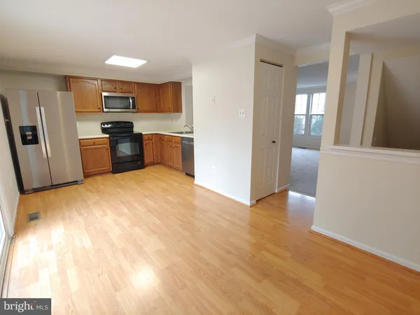 a kitchen with stainless steel appliances a refrigerator and a stove top oven