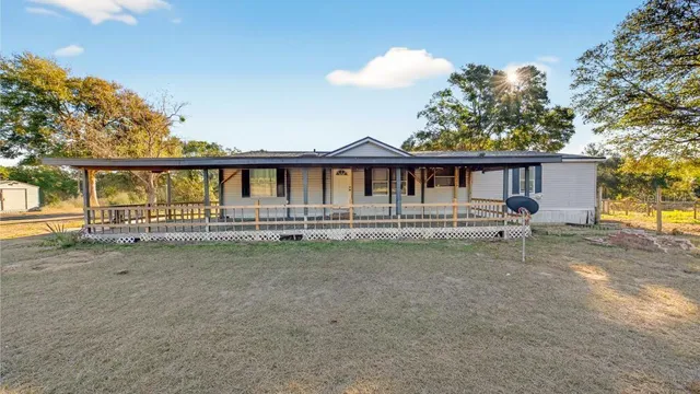 a house with swimming pool in front of it