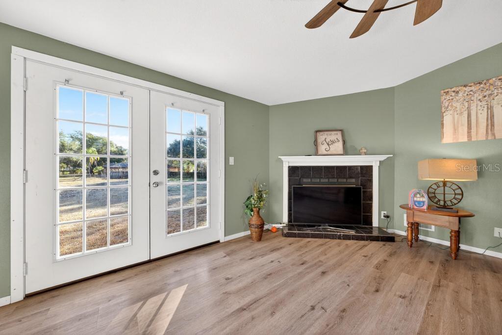 40100 Jim Scotts Road Leesburg, FL 34788 - Photo 12 of 40 a living room with furniture and a fireplace