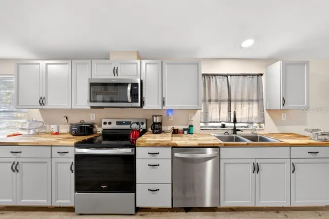 a kitchen with a sink stove and cabinets