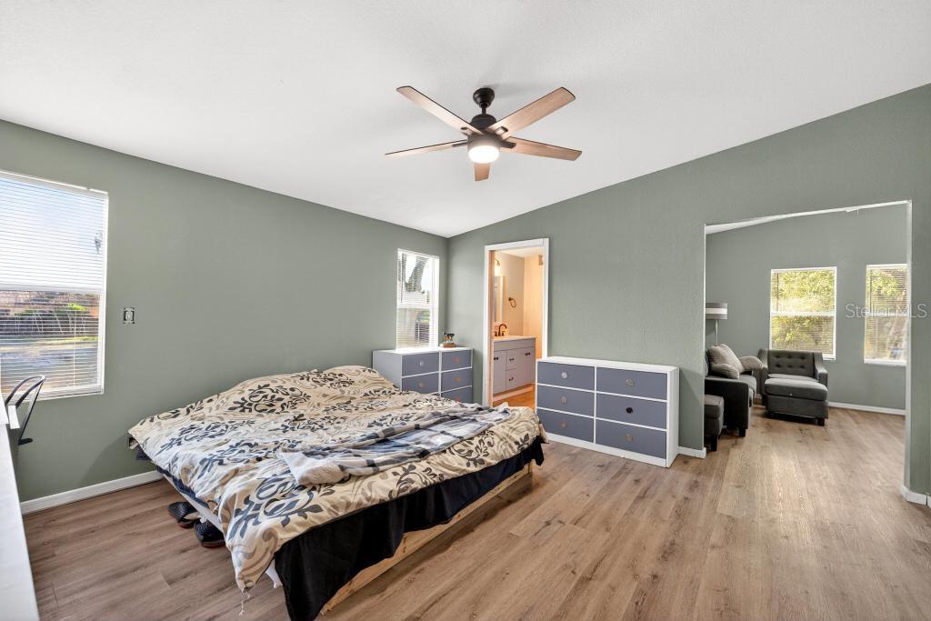 40100 Jim Scotts Road Leesburg, FL 34788 - Photo 19 of 40 a bedroom with a bed and wooden floor