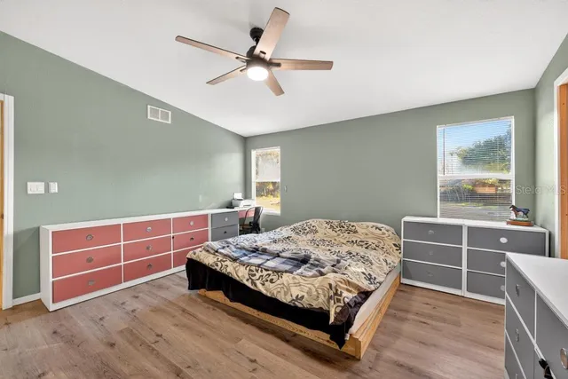 a bedroom with bed and window