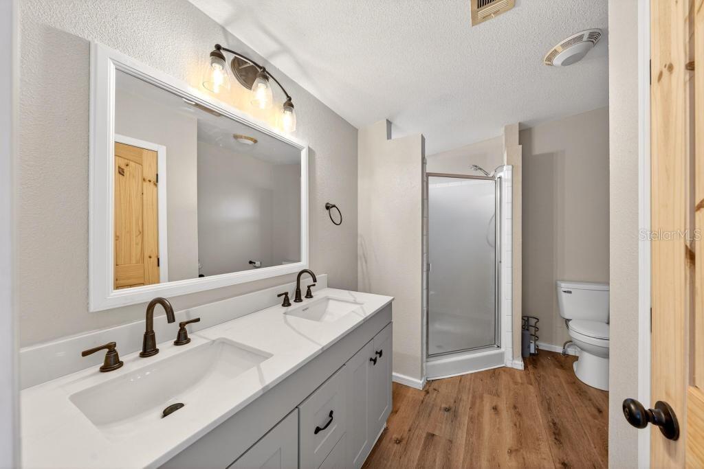 40100 Jim Scotts Road Leesburg, FL 34788 - Photo 25 of 40 a spacious bathroom with a bathtub shower sink mirror and toilet
