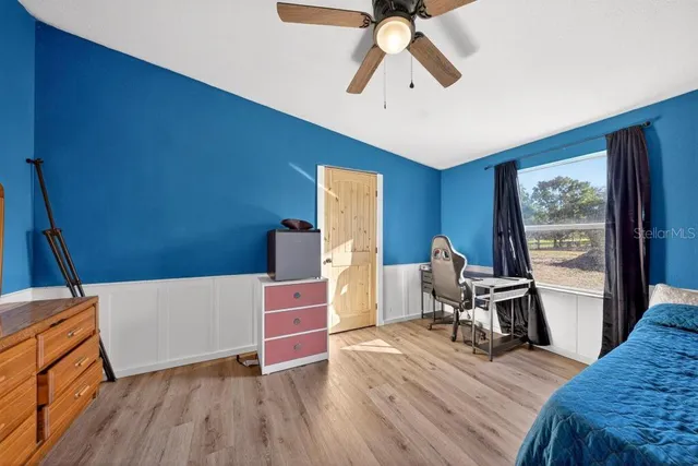 a view of workspace with wooden floor and windows