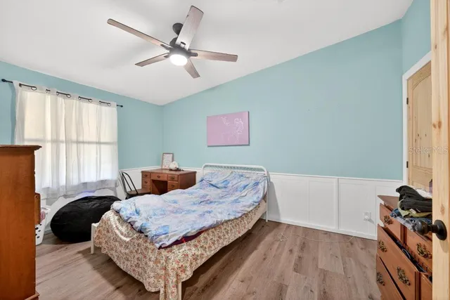 a bedroom with a bed and a window