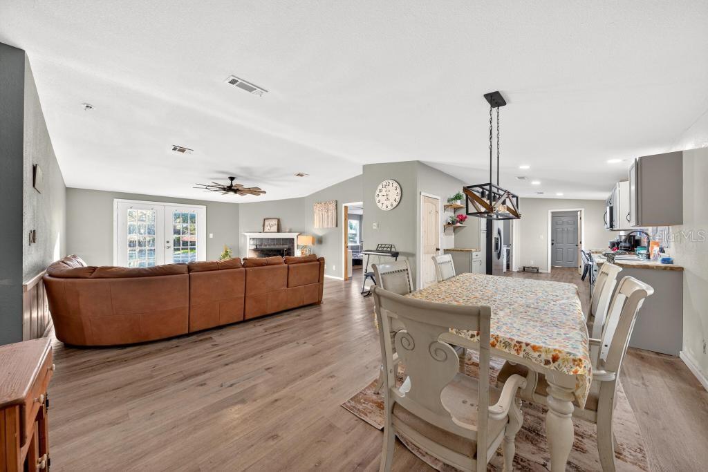 40100 Jim Scotts Road Leesburg, FL 34788 - Photo 5 of 40 a living room with furniture and kitchen view