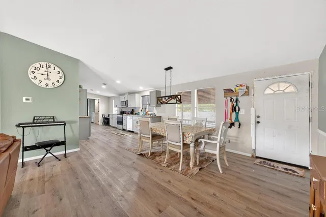 a dining room with furniture and a wooden floor