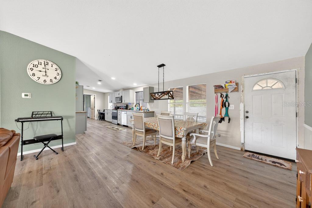 40100 Jim Scotts Road Leesburg, FL 34788 - Photo 6 of 40 a dining room with furniture and a wooden floor