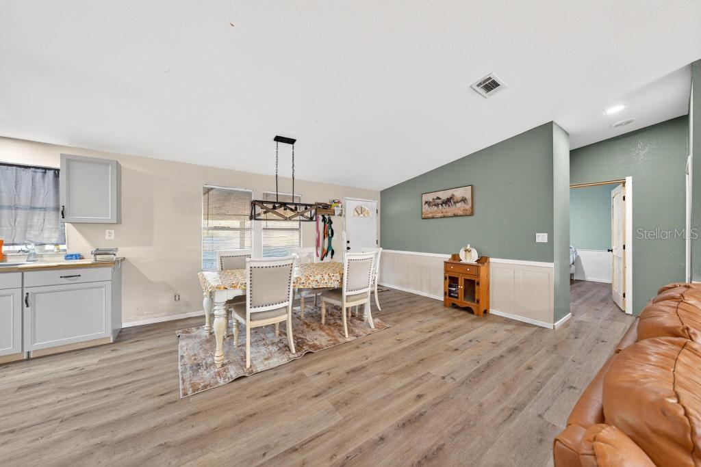 40100 Jim Scotts Road Leesburg, FL 34788 - Photo 7 of 40 a room with furniture and wooden floor