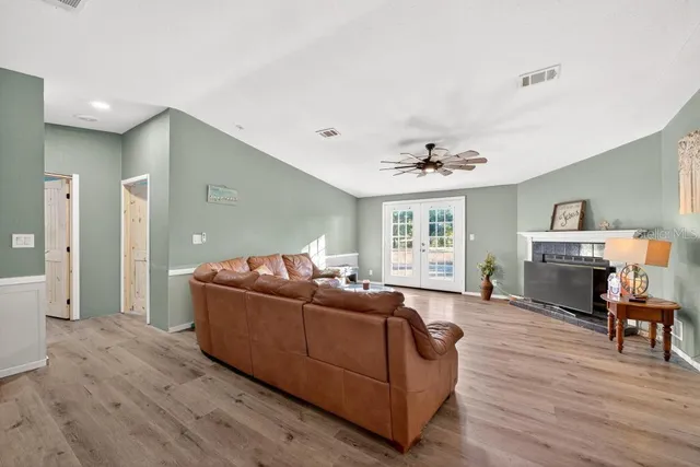 a living room with furniture and a wooden floor