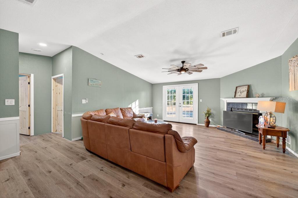40100 Jim Scotts Road Leesburg, FL 34788 - Photo 9 of 40 a living room with furniture and a wooden floor