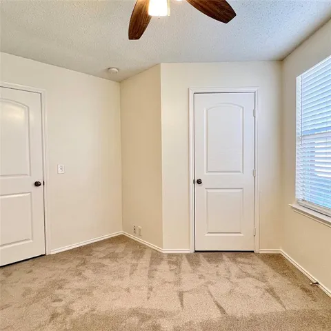 an empty room with windows and closet