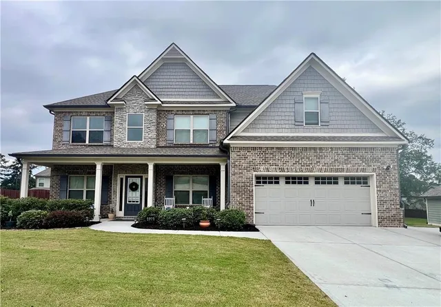 a front view of a house with a yard