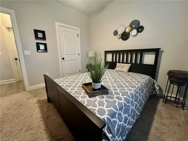 a bedroom with a large bed and a table