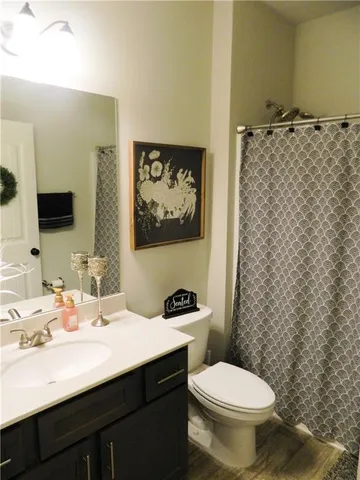 a bathroom with a sink toilet and mirror