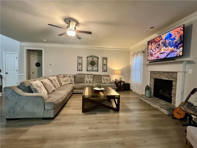 a living room with furniture and a fireplace