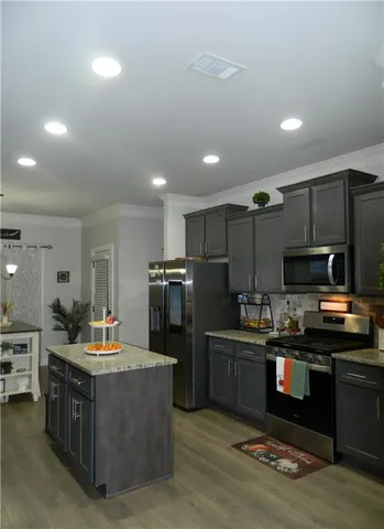 a kitchen with refrigerator and cabinets