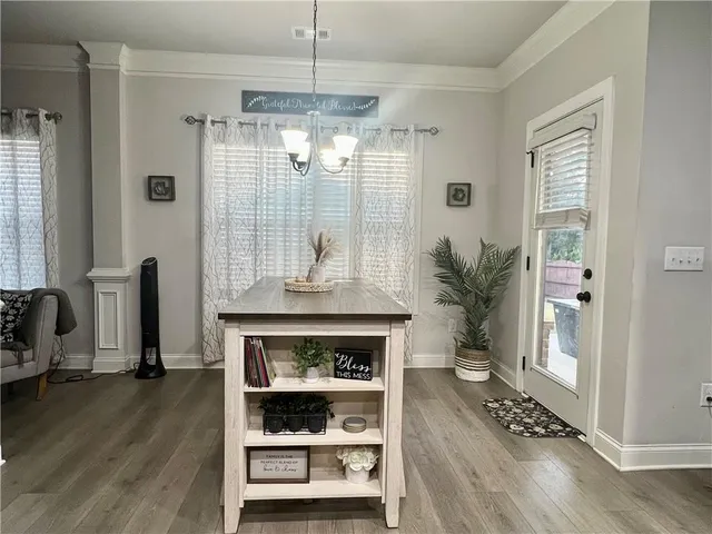 a room with wooden floor and a fireplace