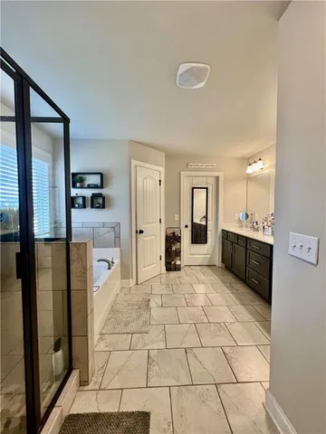 a large white kitchen with cabinets and a refrigerator