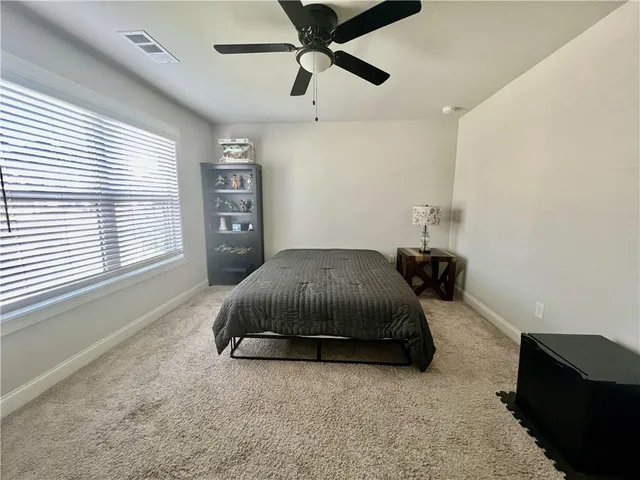 a bedroom with a bed and window