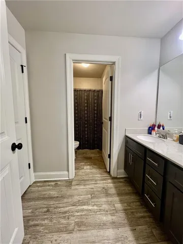 a bathroom with a double vanity sink mirror and shower